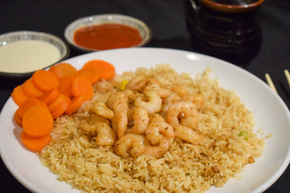 hibachi shrimp dinner with rice, carrots, and yum yum sauce mix